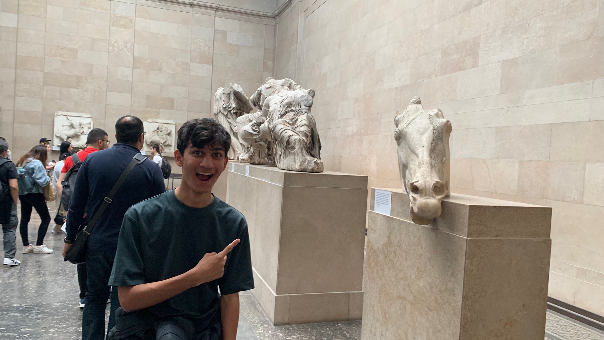 Adyan pointing to a statue of a horse